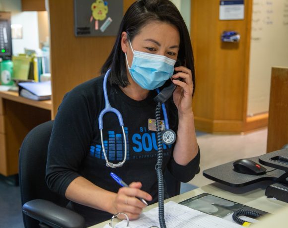 Canuck Place Nurse on phone to answer the 24-Hour Clinical Care Line