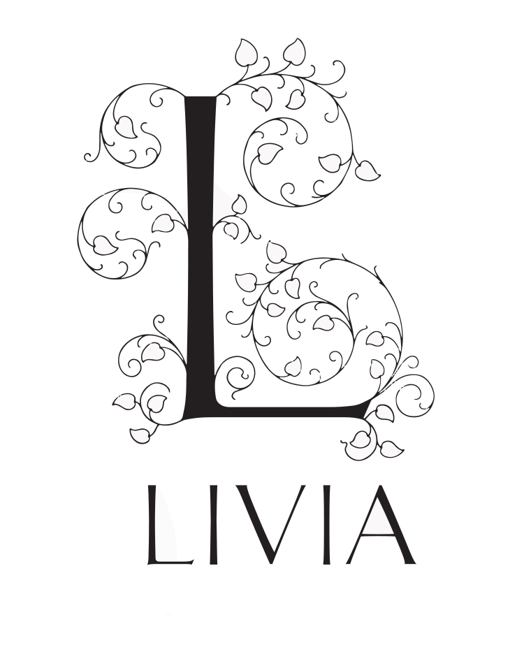 Logo for Livia sweets, featuring a large, ornate capital 'L' adorned with intricate swirls and leaf-like patterns that extend outwards. Below the decorative 'L', the name 'LIVIA' is written in a simple, clean, uppercase sans-serif font. The logo is monochrome, using only black and white.