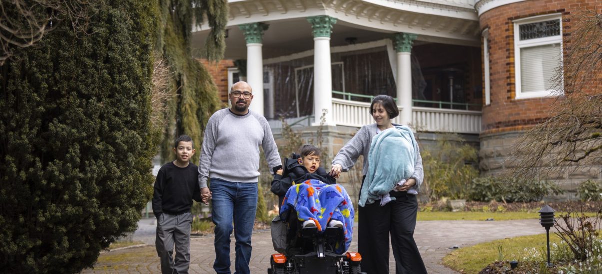 Canuck Place family in front of Canuck Place Vancouver - Glen Brae Manor