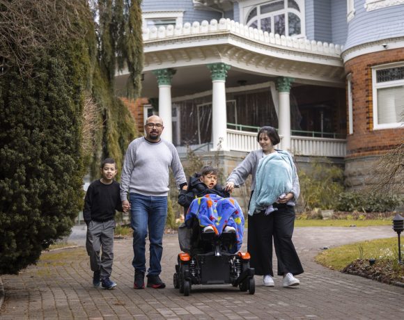 Canuck Place family in front of Canuck Place Vancouver - Glen Brae Manor