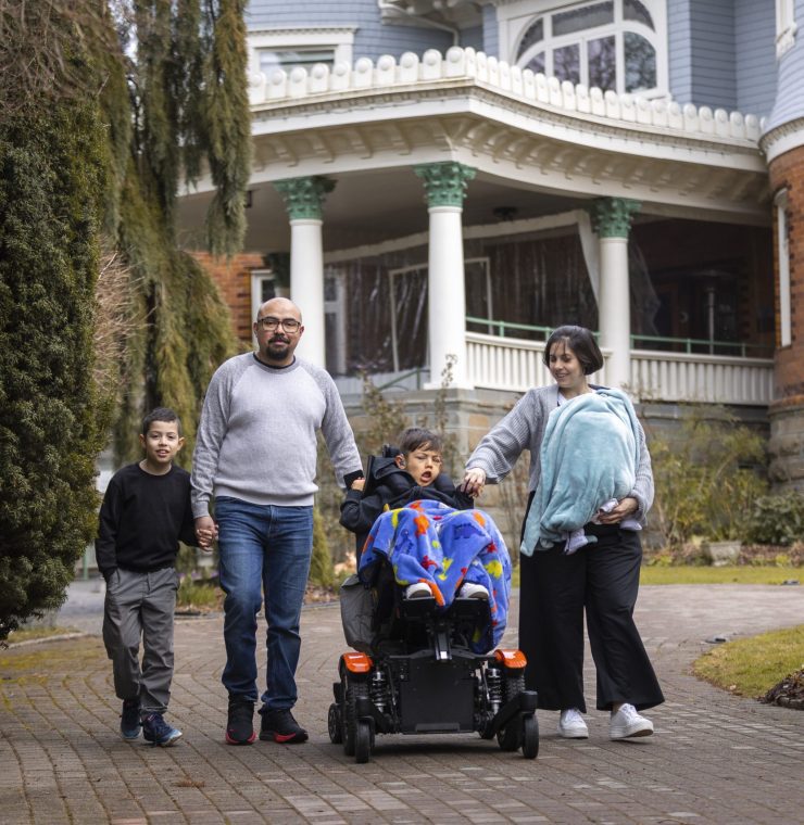 Canuck Place family in front of Canuck Place Vancouver - Glen Brae Manor