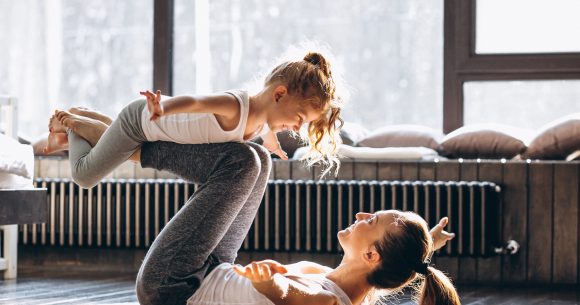 A mother and a child exercising together