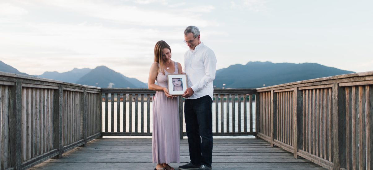 Marie and Wes Toews with a picture of baby Sophia