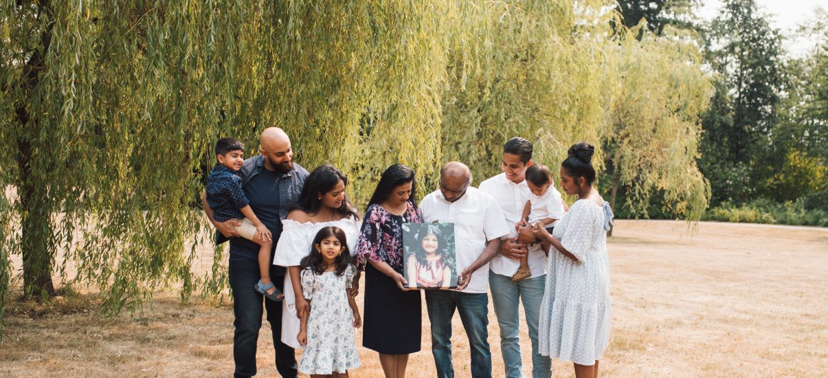 The Premia Family holding a picture of Angelina