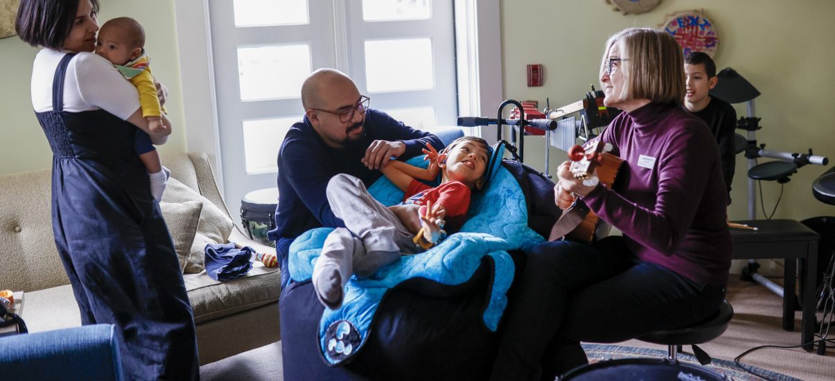 The Hernandez family with Canuck Place music therapist, Michaela