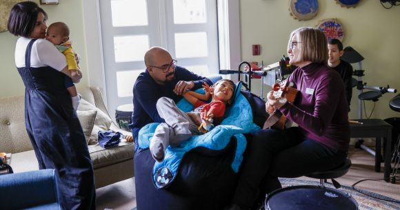 The Hernandez family with Canuck Place music therapist, Michaela